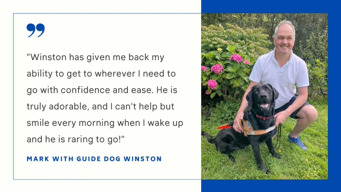 Mark is smiling while kneeling next to a black labrador named Winston who is also giving a huge smile!