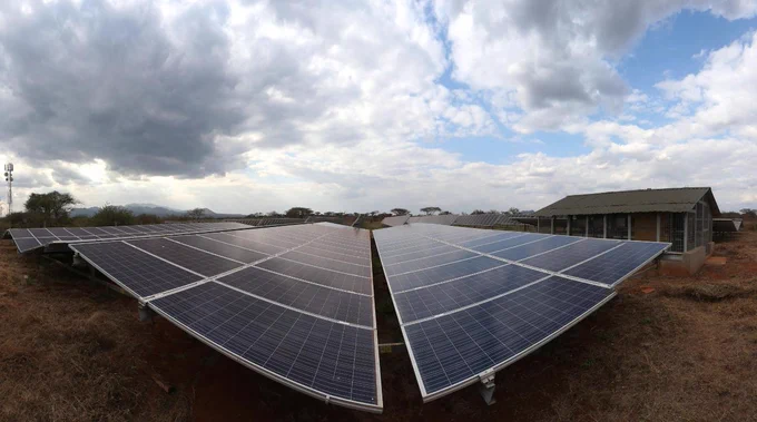 Picture from Getty Images: Solar panels, rural setting, clouds above.