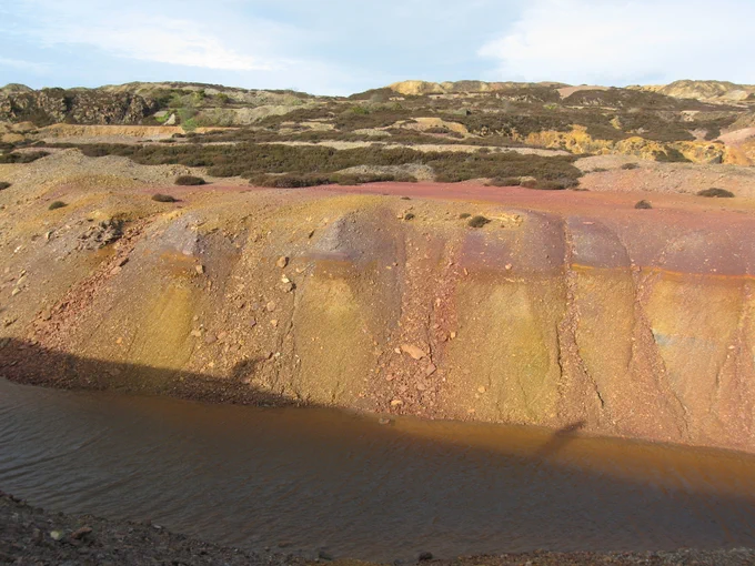 Historic mine tailings at Parys Mountain, Wales. New processing can produce cleaner tailings but we need to avoid unintended consequences.