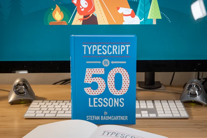 The book in front of the screen with a Smashing background.