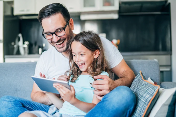 Father and daughter viewing a GMS Video Destination Spotlight prior to relocating to a new city