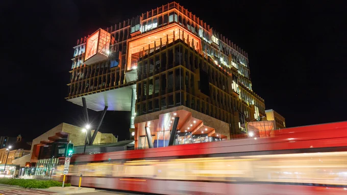 NUspace lit up with orange lights at night
