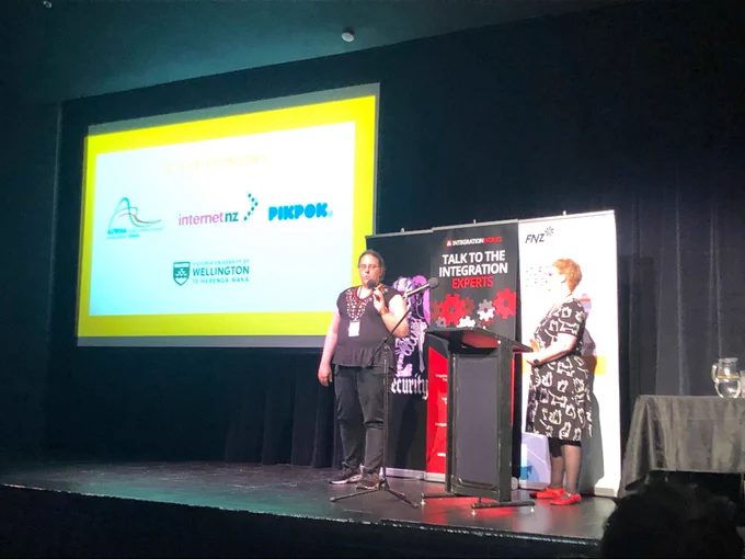 Kate Pearce, InternetNZ Councillor on stage at WITcon talking about InternetNZ