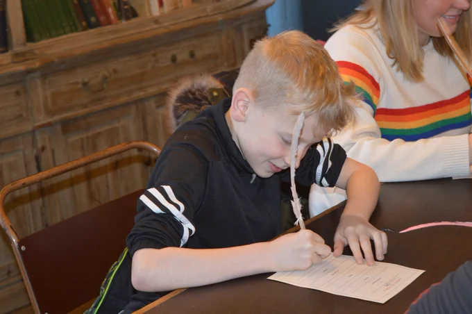 Child enjoying writing at a Grimm and co event