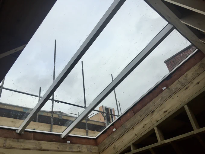 Photo looking up through the sky-light of the LGBT  centre rebuild