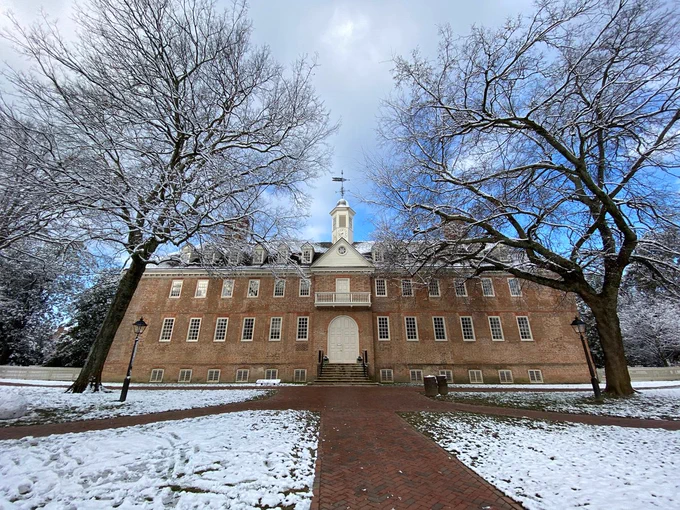The front of the Wren Building in winter with a little amount of snow on the ground.