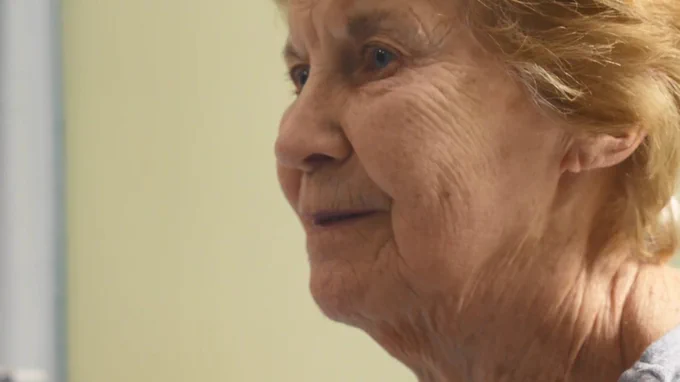 Close-up of Maggie, smiling to left of shot.