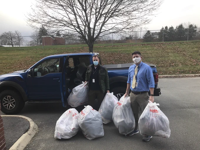 C&L Aviation Group CEO Chris Kilgour donating jackets to JFDS Assistant Principal Sam Moring.