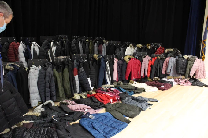 100 winter jackets on the stage at JFDS.