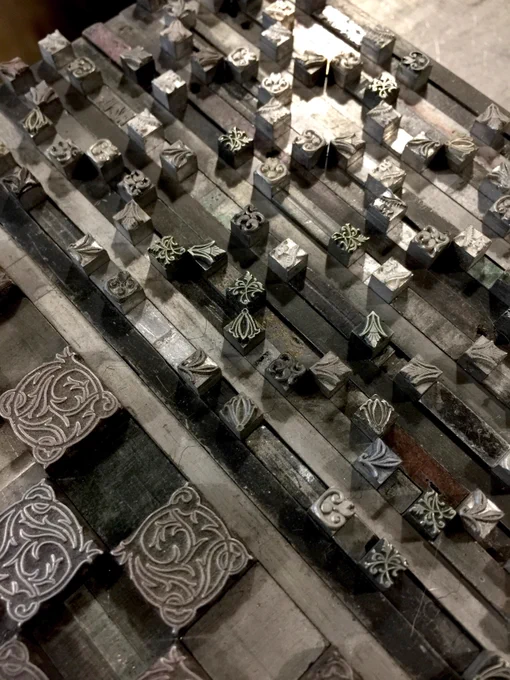 a photo of the handset lead pieces used to print the pattern, each individual flower arranged in a grid.