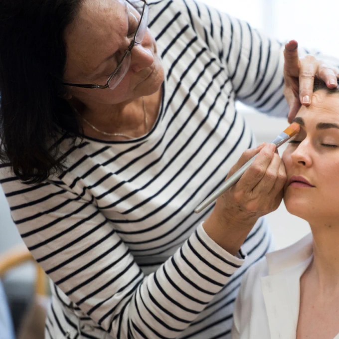Photo of Carmen applying makeup to Caitlin Wood, Soprano during 2017's The Marriage of Figaro, taken by Emily Cooper.
