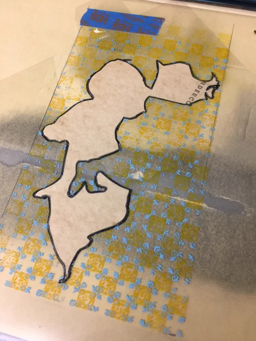 the masking system for printing in the irregular shape of the clothing, where mylar protects the sheet from being printed outside the lines, and extra thickness is packed behind the sheet where it wants to be printed.