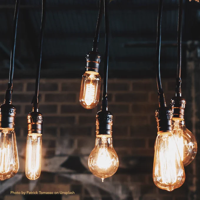 Photo of various types of illuminated hanging light bulbs, by Patrick Tomasso on Unsplash