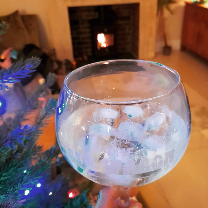 Gin glass in front of log burner