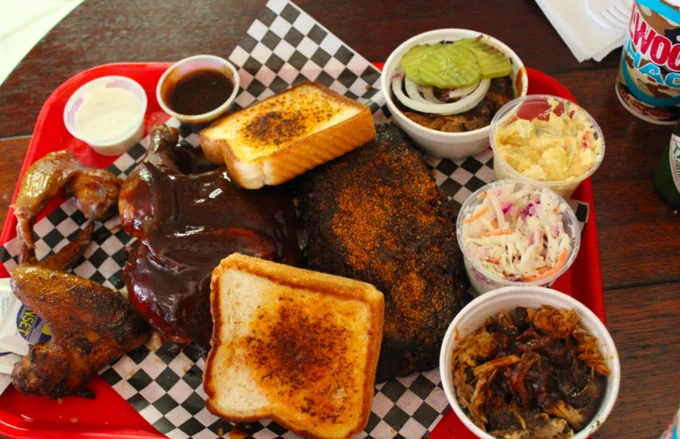 Platter of bbq meats, cole slaw, texas toast, and chicken wings from Elwood's Shack.