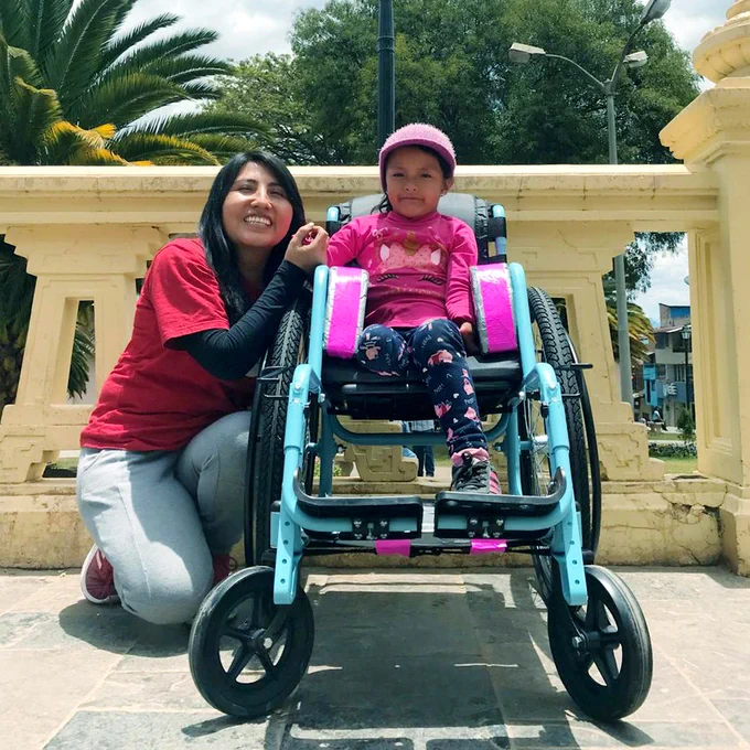 Mayuri after in her new wheelchair with a volunteer