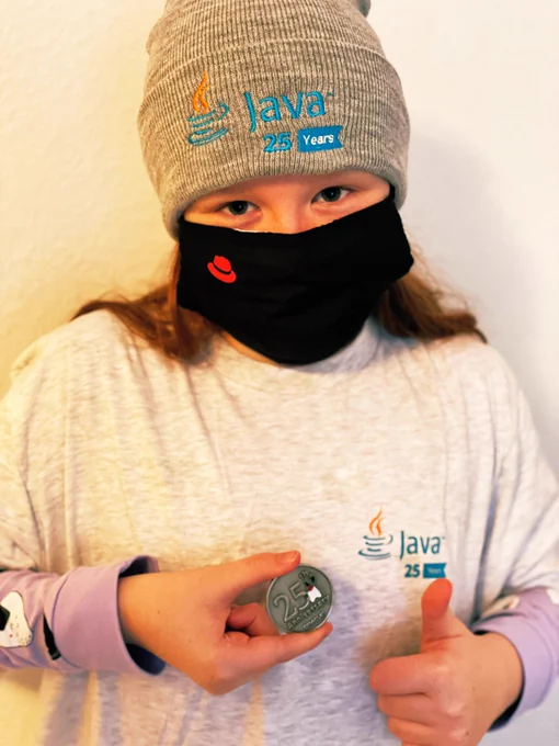 My little girl wearing a Java beanie, holding a Java Coin wearing a java tshirt giving all of you a thumbs up!