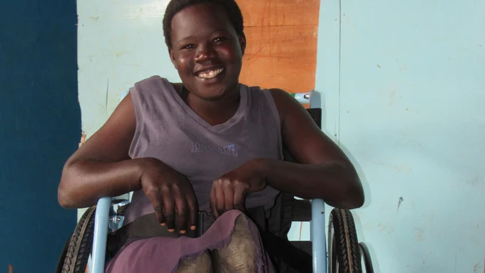 Perpetwa smiling in her new wheelchair