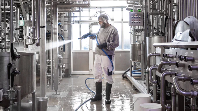 Person spraying cleaning solution.