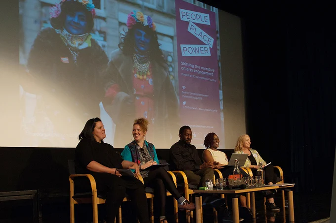Four speakers sit in front of a projection screen at the 2018 CPP Conference