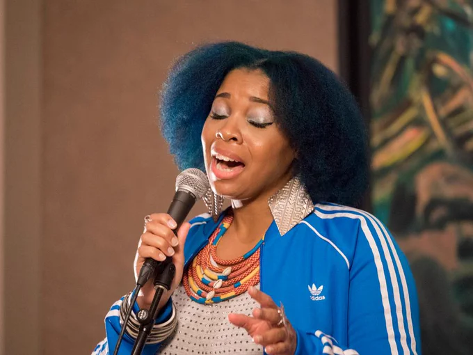 Woman sings into microphone