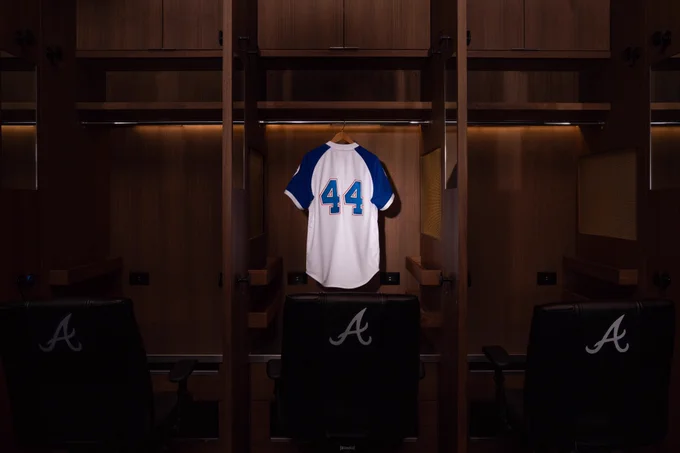 Hank Aaron‘s 44 jersey hangs in an otherwise empty locker room.