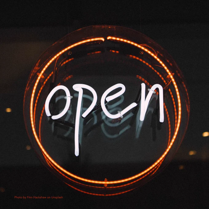 Photo of a neon "open" sign by Finn Hackshaw on Unsplash