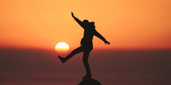 Someone aiming a kick against the setting sun