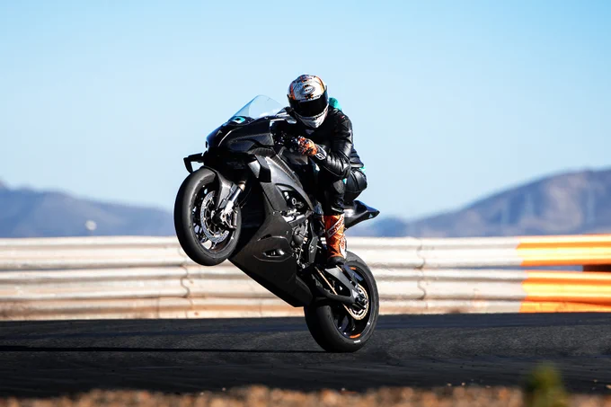 Professional motorcycle racer, Peter Hickman, doing a wheelie on his rear wheel at the spanish circuit of Cartagena. He is riding a new BMW M 1000 RR equipped with alpha Racing Performance Parts.