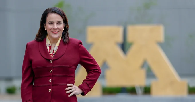 President Gabel stands in front of a Block M sculpture on the University of Minnesota campus. 