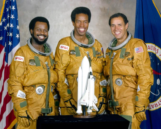 Astronauts Dr. Ronald McNair, Guy Bluford and Fred Gregory pose for portrait wearing spacesuits