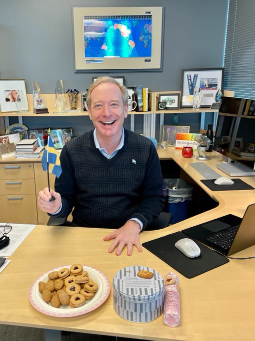 Brad Smith with a Swedish flag and Swedish cookies sitting at his desk