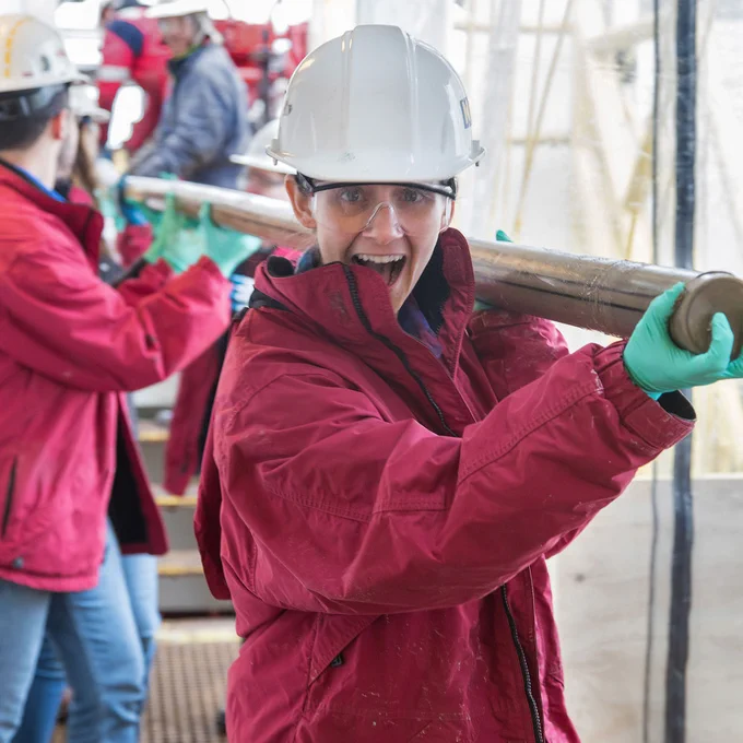 Nicolette Lawler (Marine Laboratory Specialist, IODP JRSO) leads the way with the first core of Expedition 379.
