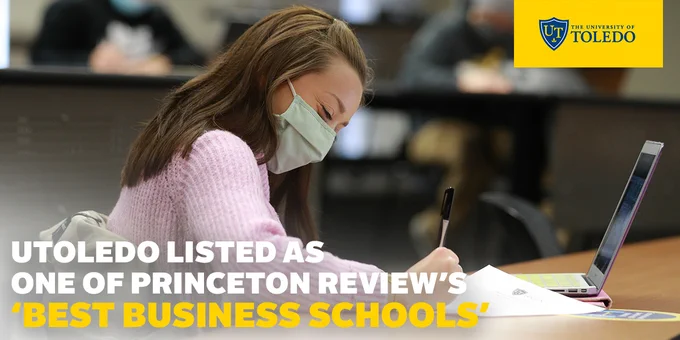 Photo of a girl in a mask working on her laptop Text: Utoledo listed as one of Princeton Review's "Best Business Schools"