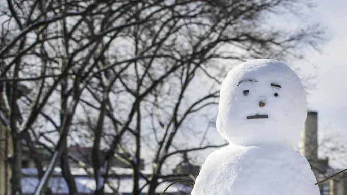 A photo of a snowman in front of Hamerschlag Hall on the campus of Carnegie Mellon University in Pittsburgh, Pennsylvania.
