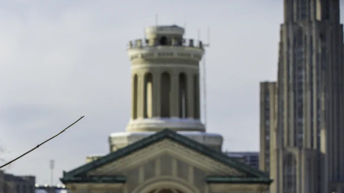 A photo of a snowman in front of Hamerschlag Hall on the campus of Carnegie Mellon University in Pittsburgh, Pennsylvania.