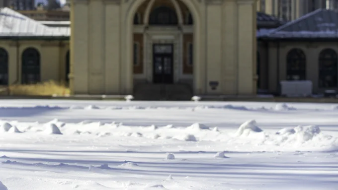 A photo of a snowman in front of Hamerschlag Hall on the campus of Carnegie Mellon University in Pittsburgh, Pennsylvania.