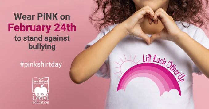 Image of young person wearing a white shirt with pink rainbow and words "Lift Each Other Up" on it, holding their hands together in the shape of a heart. Text: "Wear PINK on February 24th to stand against bullying. #PinkShirtDay" AMDSB logo
