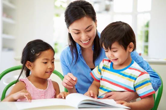 Mother with son and daughter reading together