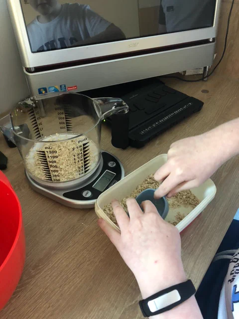 Len uses the talking scoop to pick up the right amount of oats for his flapjacks