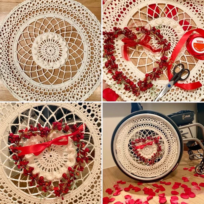 This image has the steps of Kate’s decorating in four images - 2 rows of 2 images. The image at the top right is just Kate’s plain, but fabulous ivory crocheted wheel cover laying on the floor, the photo to the left is a zoomed-in image of her wheel cover with the heart-shaped faux branch with red faux berries and roll of red ribbon. The picture on the bottom right is a zoomed-in image of Kate’s wheel cover attached to her wheelchair wheel and decorated. The last photo is a more zoomed-out image of Kate’s decorated wheelchair wheel, with red rose pedals scattered on the ground. We love that Kate feels that her wheelchair is her vehicle that can also be a fashion accessory.
