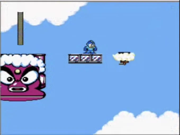 Mega Man alone on a platform in the sky, a big menacing robot behind him, a tiny precarious cloud ahead of him to jump to, nothing but more sky beyond that.