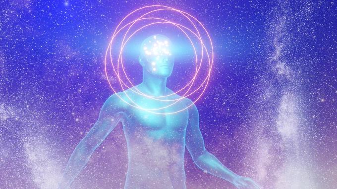 The same man, now standing over the entire universe. His brain is now so bright that his face is difficult to see. Concentric circles are visible around his head.
