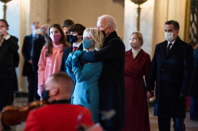 President Joe Biden embraces First Lady Dr. Jill Biden in the Grand Foyer of the White House Wednesday, Jan. 20, 2021, as the United States Marine Band plays to welcome them to the White House.