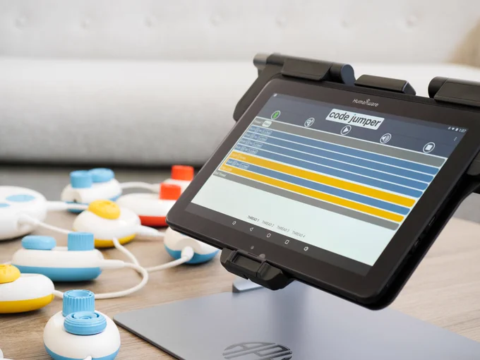 a matt connect on a table with code jumper pods around it. the screen shows the code jumper app