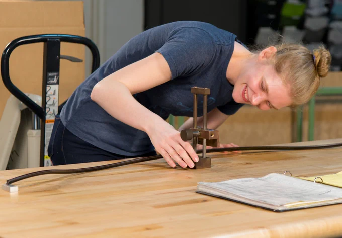 Young woman measuring a table