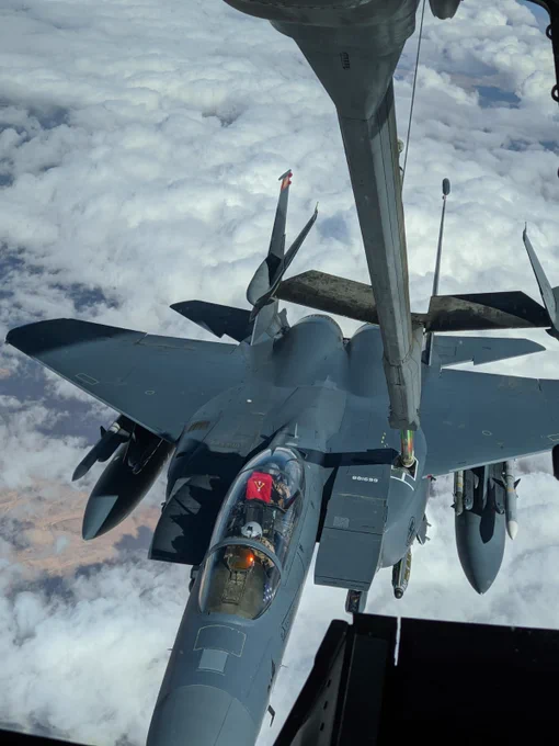 Rod James ’04 raises a red VMI flag as BR Derek Rankin ’05 refuels James’ F-15E in the air. 