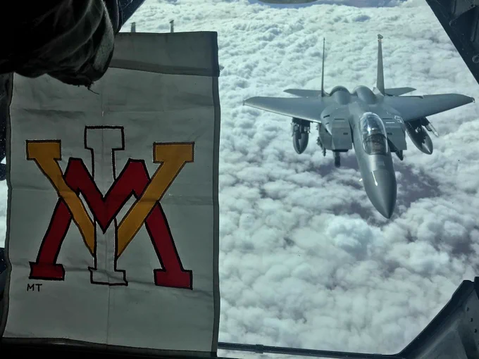  Derek Rankin ’05 raises a white VMI flag to the window as Rod James ’04 flies his F-15E below. 