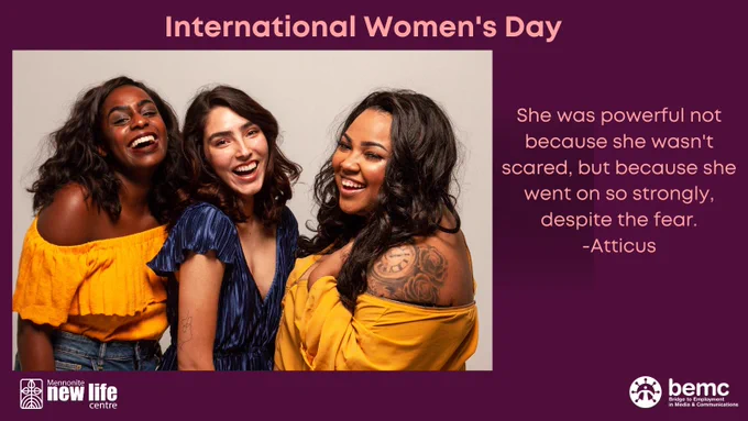 Three women of different cultural backgrounds standing together and smiling.