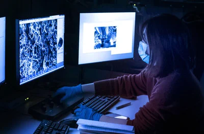 Rong Kou, an assistant research professor in the Department of Mechanical Engineering, uses a scanning electron microscope at Penn State's Millennium Science Complex to study the crystalline structure of a lithium metal oxide.